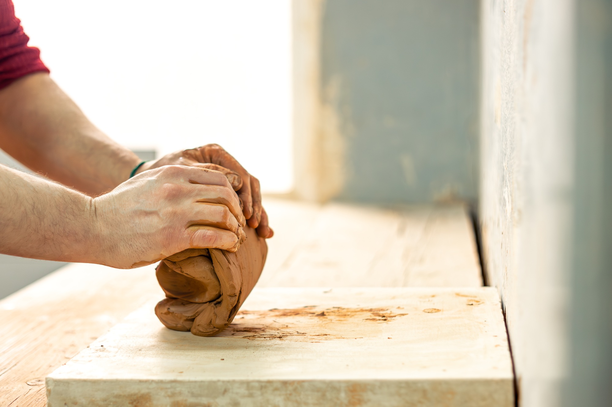 Ceramicist-potter at work. Modeling from clay. Preparing for pottery. Clay in hands.