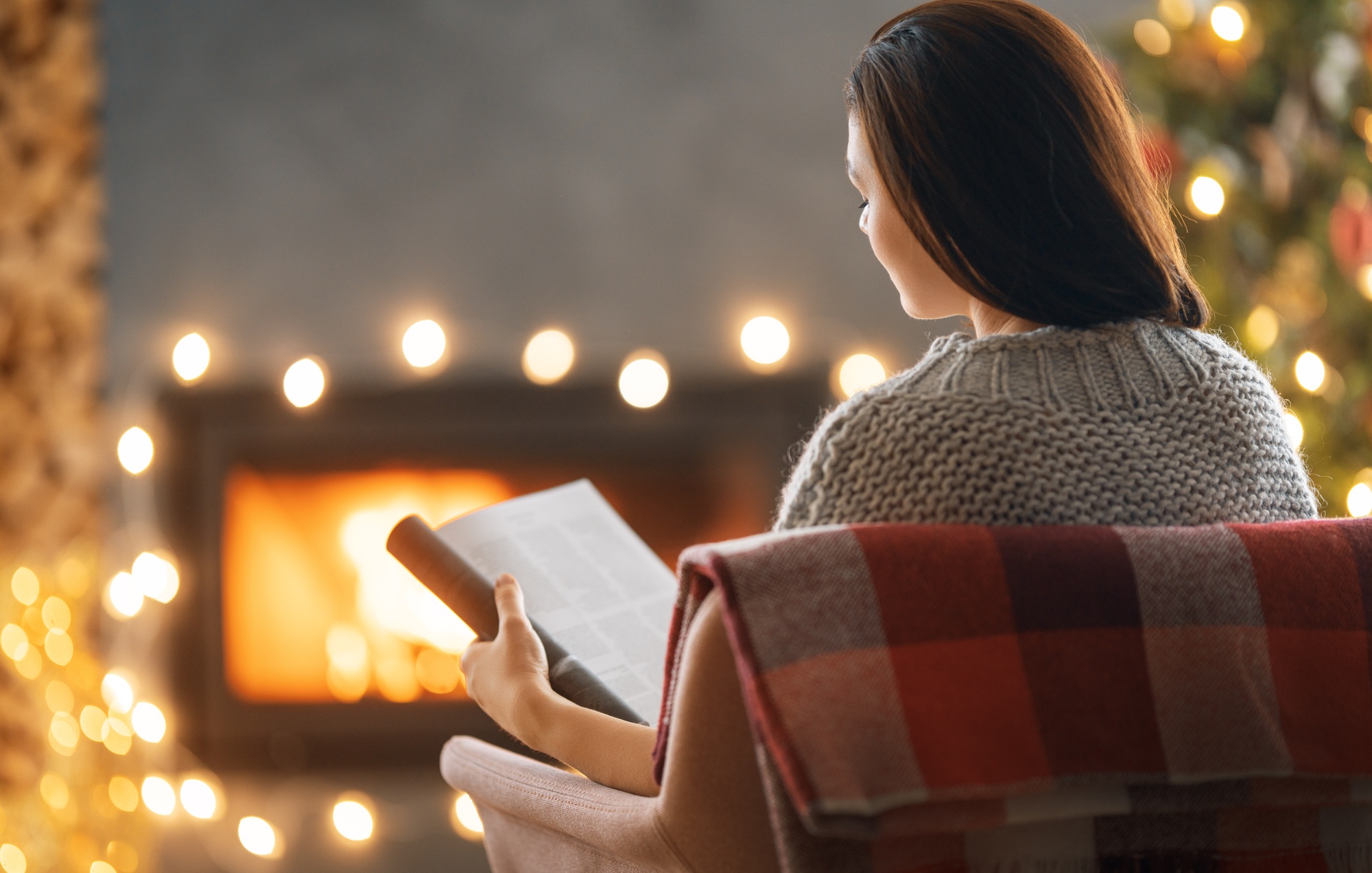 woman is relaxing near Christmas tree