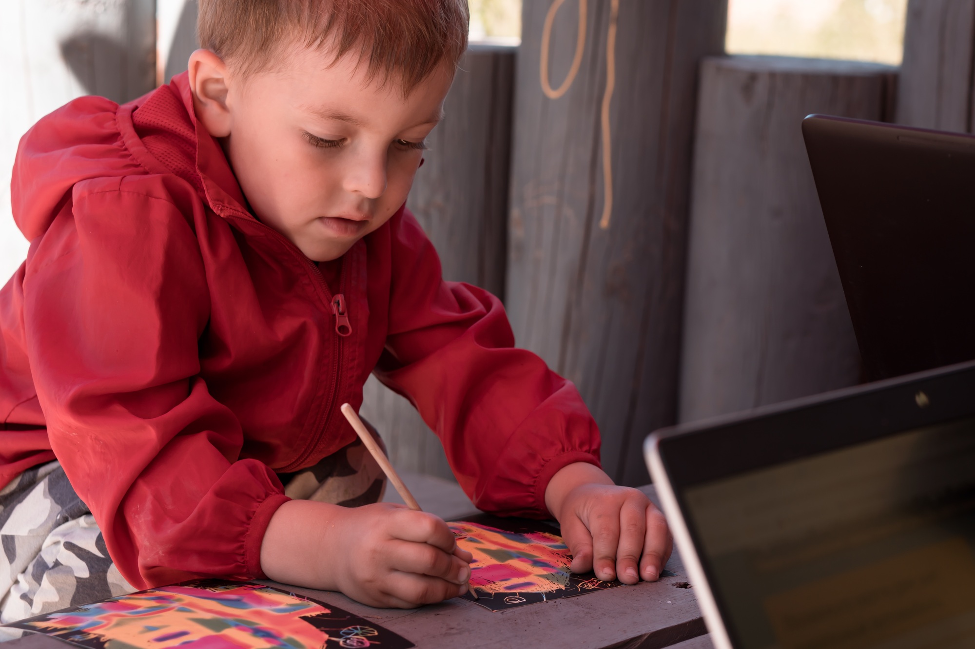 boy draws outdoors