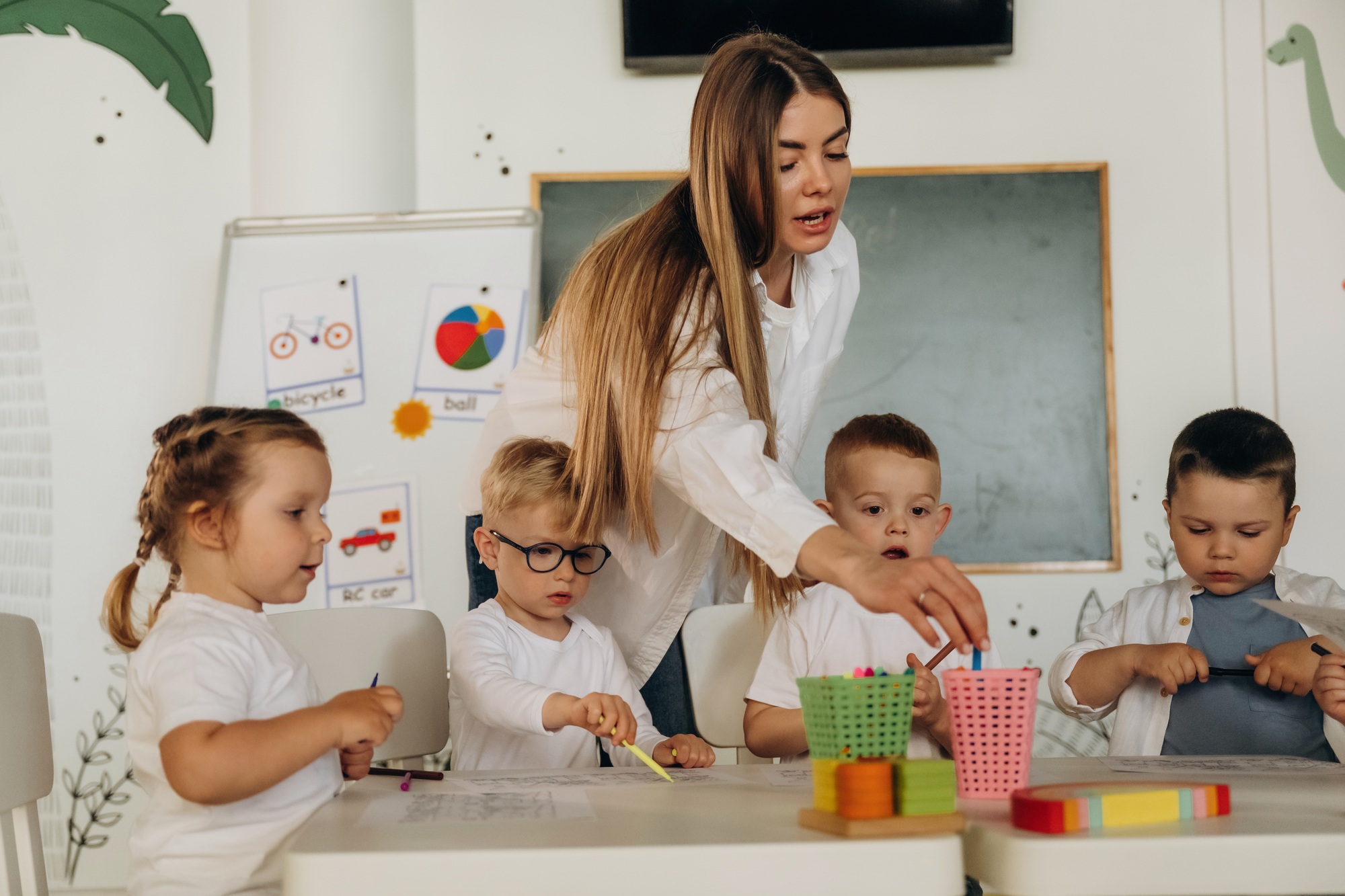 Colorful toys, educational game. Children in kindergarten with their teacher