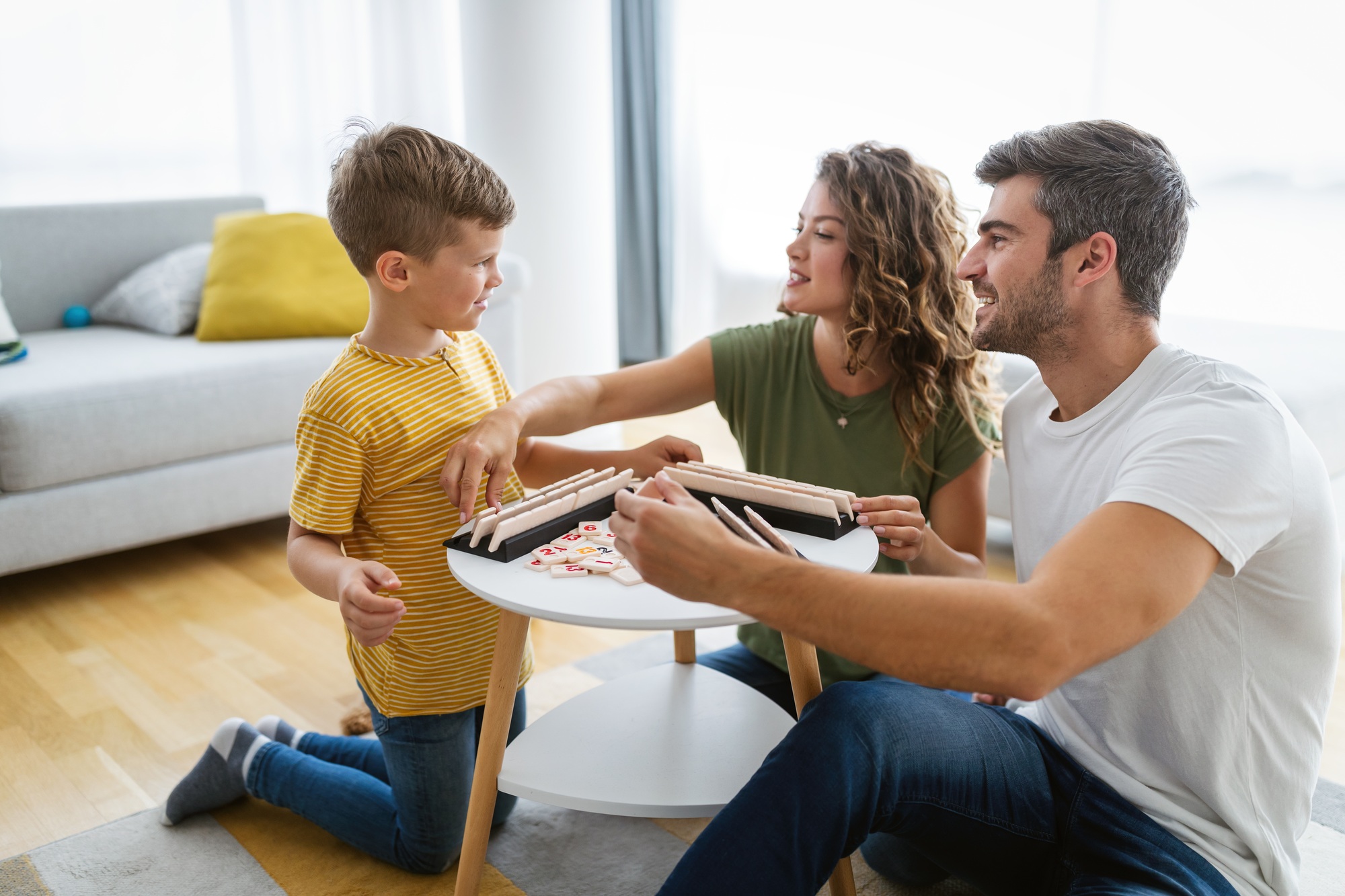 Young happy family having fun, playing together at home