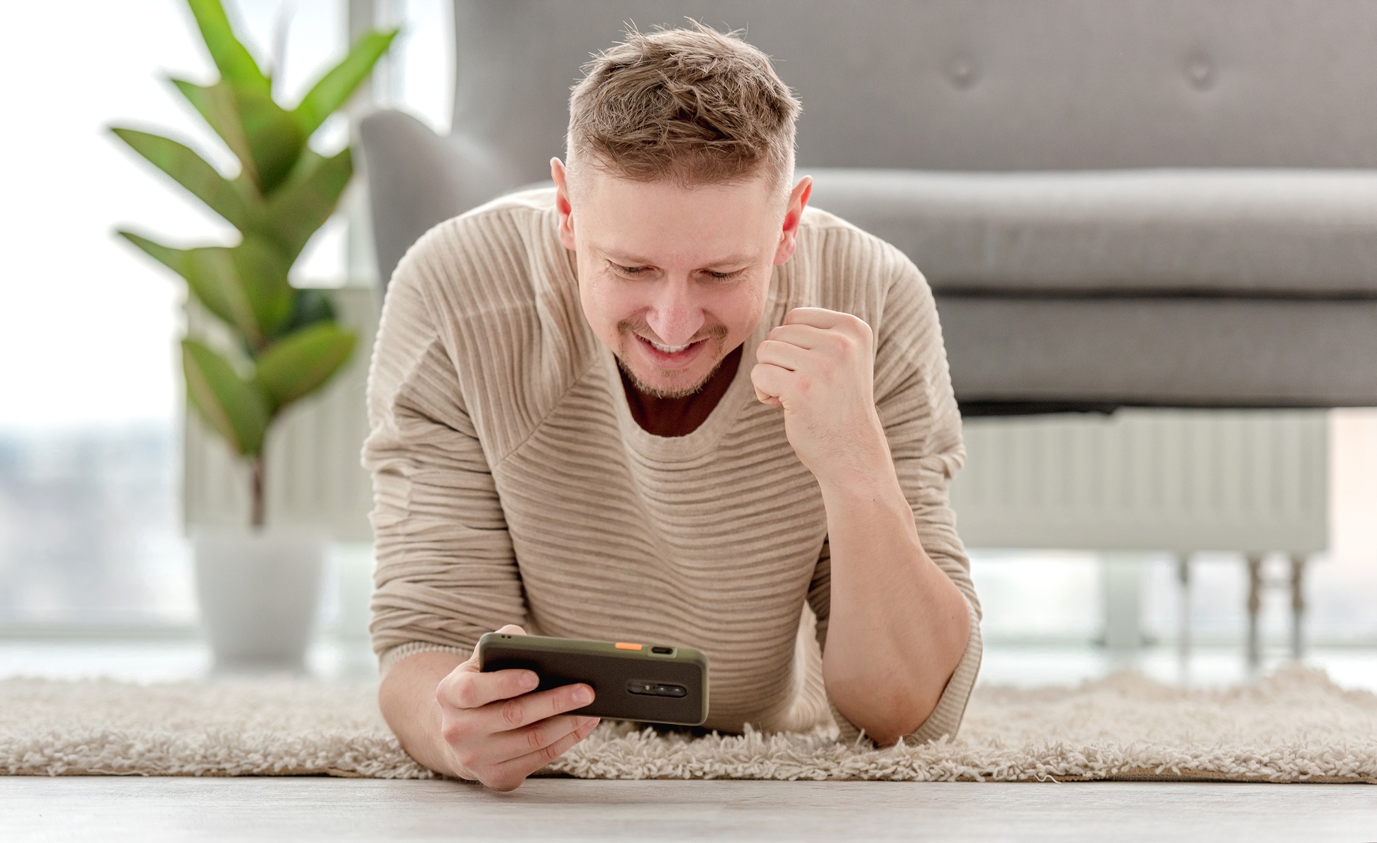 Man plays games on smartphone